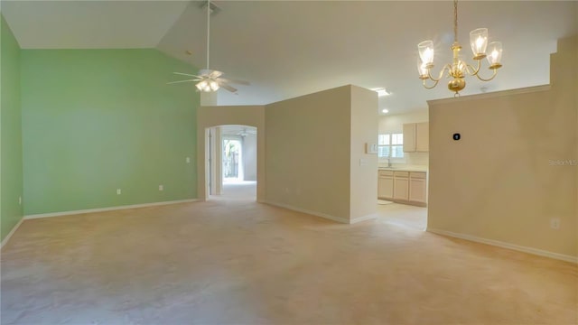 949 Woodsong Way, Clermont, FL 34714 - unfurnished room featuring ceiling fan, a chandelier, arched walkways, lofted ceiling, and light carpet