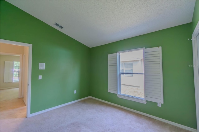 949 Woodsong Way, Clermont, FL 34714 - spare room featuring carpet flooring, a textured ceiling, and lofted ceiling
