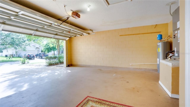 949 Woodsong Way, Clermont, FL 34714 - garage featuring water heater, concrete block wall, and a garage door opener