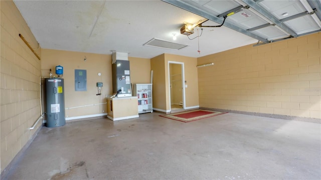 949 Woodsong Way, Clermont, FL 34714 - garage with electric water heater, electric panel, concrete block wall, and a garage door opener