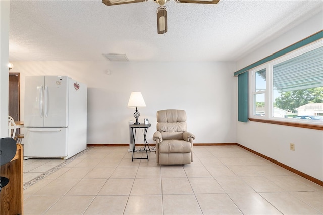 8247 SW 105th Pl, Ocala, FL 34481 - sitting room featuring a ceiling fan, a textured ceiling, and light tile patterned flooring