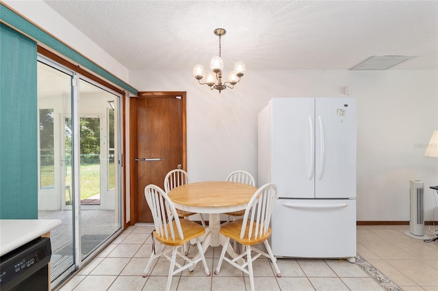 8247 SW 105th Pl, Ocala, FL 34481 - dining room with light tile patterned floors, a chandelier, and a textured ceiling