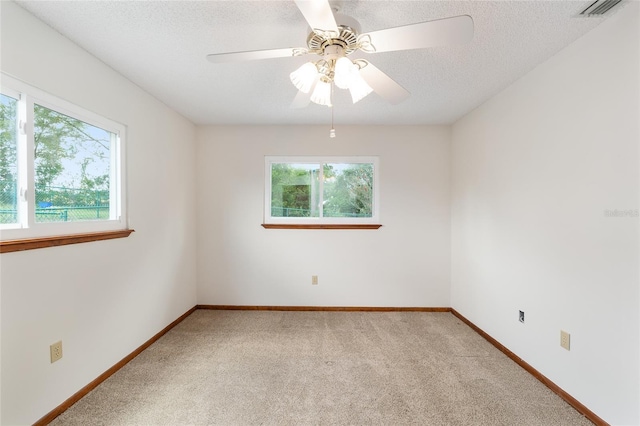 8247 SW 105th Pl, Ocala, FL 34481 - unfurnished room featuring plenty of natural light, light colored carpet, a ceiling fan, and a textured ceiling