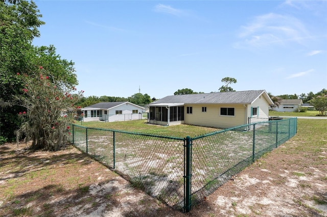 8247 SW 105th Pl, Ocala, FL 34481 - back of house featuring a sunroom and a fenced backyard