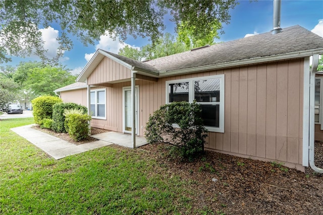 2864 SW 40th Ave, Gainesville, FL 32608 - view of side of property featuring a shingled roof and a yard