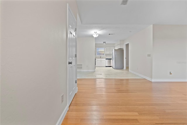 2864 SW 40th Ave, Gainesville, FL 32608 - hall featuring light wood-style floors and baseboards