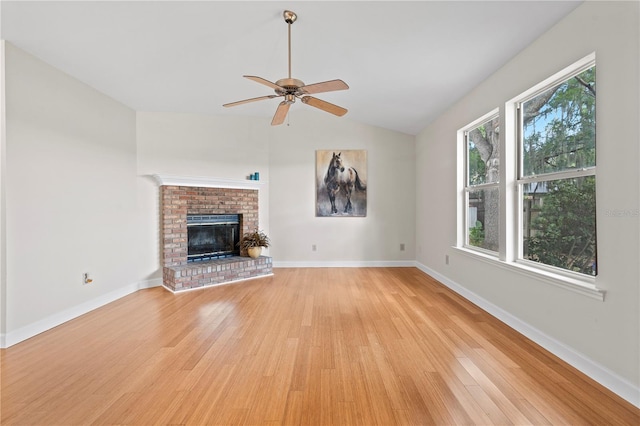 2864 SW 40th Ave, Gainesville, FL 32608 - unfurnished living room featuring light wood-style flooring, vaulted ceiling, a ceiling fan, and a fireplace
