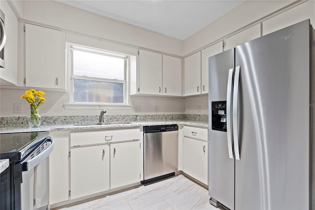 2864 SW 40th Ave, Gainesville, FL 32608 - kitchen featuring appliances with stainless steel finishes, white cabinetry, and light stone counters