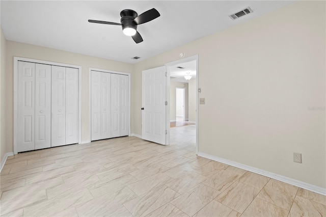 2864 SW 40th Ave, Gainesville, FL 32608 - unfurnished bedroom featuring multiple closets and a ceiling fan