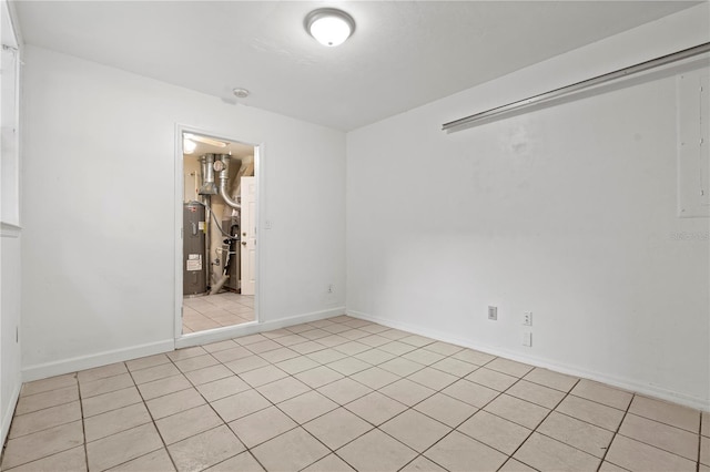 2864 SW 40th Ave, Gainesville, FL 32608 - empty room featuring water heater and light tile patterned flooring