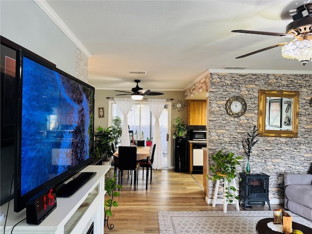 8547 SW 106th Pl, Ocala, FL 34481 - living area with ceiling fan, a wood stove, crown molding, and light wood-type flooring