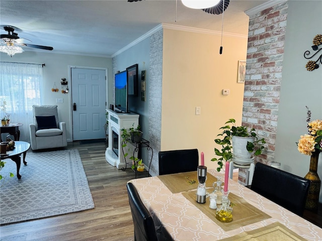 8547 SW 106th Pl, Ocala, FL 34481 - dining area featuring ceiling fan, wood finished floors, ornamental molding, and a fireplace
