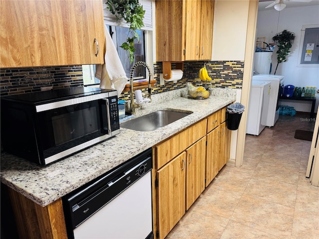 8547 SW 106th Pl, Ocala, FL 34481 - kitchen with white dishwasher, washer and dryer, stainless steel microwave, electric panel, and gas water heater