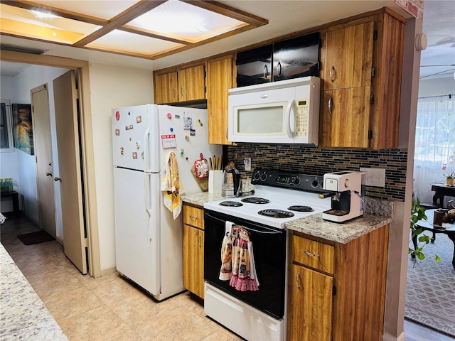 8547 SW 106th Pl, Ocala, FL 34481 - kitchen with white appliances, brown cabinets, and backsplash