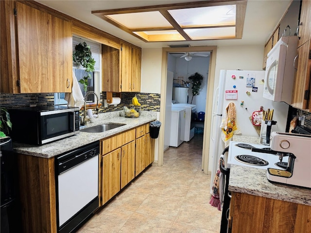 8547 SW 106th Pl, Ocala, FL 34481 - kitchen with white appliances, tasteful backsplash, washer and clothes dryer, ceiling fan, and brown cabinets