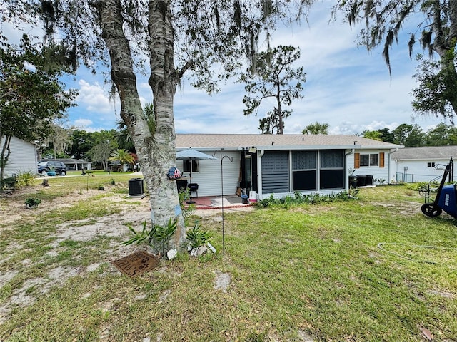 8547 SW 106th Pl, Ocala, FL 34481 - back of house with a patio area, a yard, and a sunroom