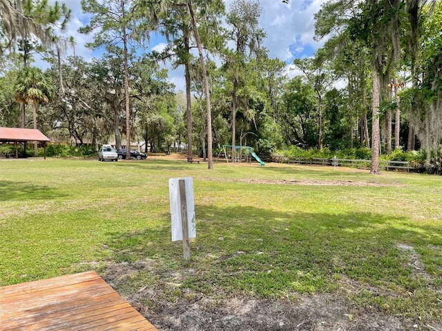 1112 NE 130th Ter, Silver Springs, FL 34488 - view of green lawn with a gazebo and view of wooded area