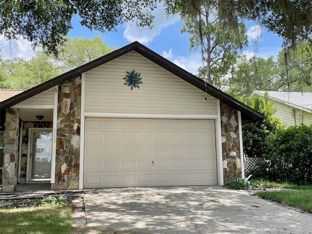1112 NE 130th Ter, Silver Springs, FL 34488 - view of front of house with stone siding, an attached garage, and concrete driveway