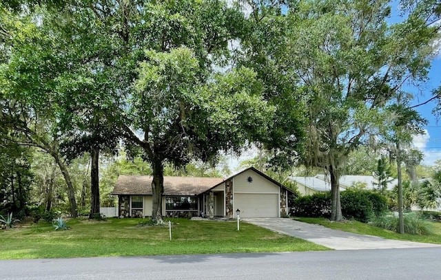 1112 NE 130th Ter, Silver Springs, FL 34488 - view of front of house featuring a garage, a front lawn, and driveway