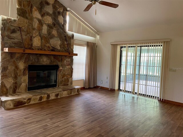 1112 NE 130th Ter, Silver Springs, FL 34488 - unfurnished living room featuring ceiling fan, wood finished floors, high vaulted ceiling, and a stone fireplace