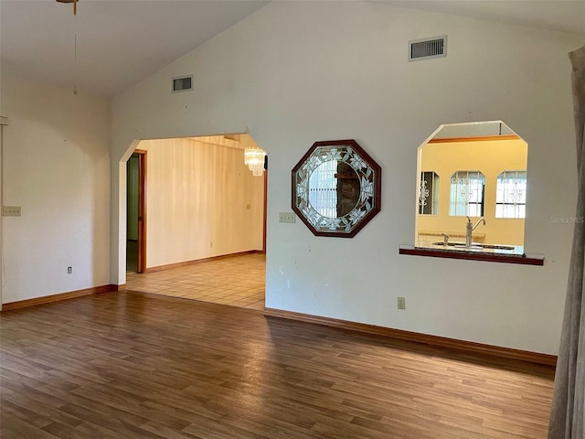 1112 NE 130th Ter, Silver Springs, FL 34488 - unfurnished room featuring high vaulted ceiling and wood finished floors