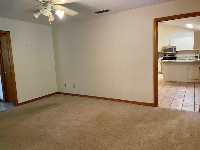 1112 NE 130th Ter, Silver Springs, FL 34488 - spare room featuring light carpet and a ceiling fan
