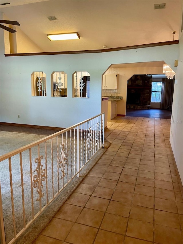 1112 NE 130th Ter, Silver Springs, FL 34488 - hallway with tile patterned flooring and a chandelier