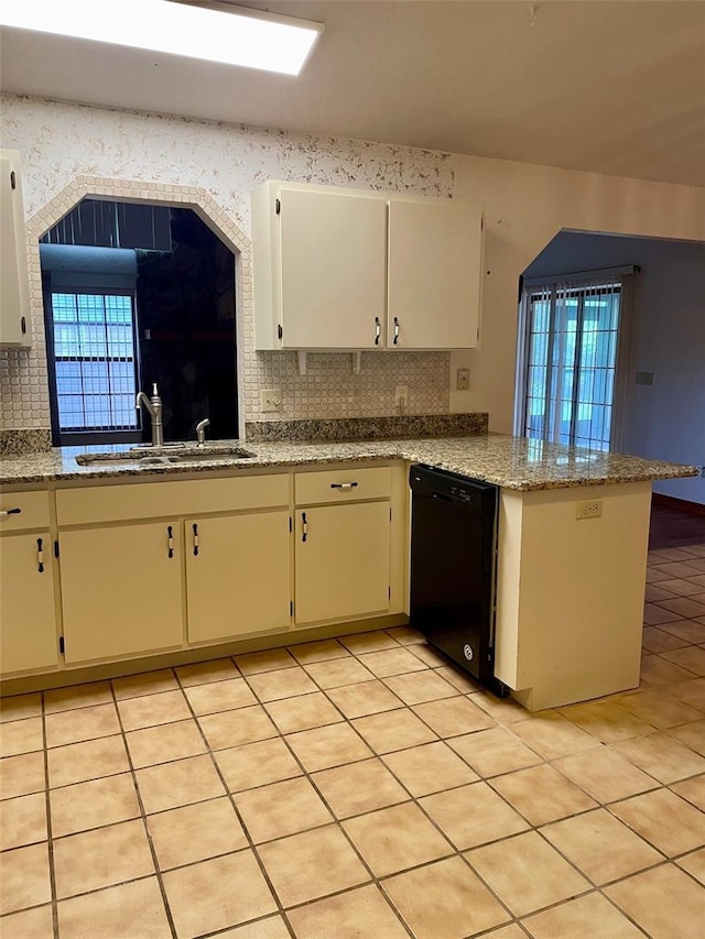 1112 NE 130th Ter, Silver Springs, FL 34488 - kitchen with dishwasher, tasteful backsplash, a peninsula, light tile patterned floors, and light stone counters