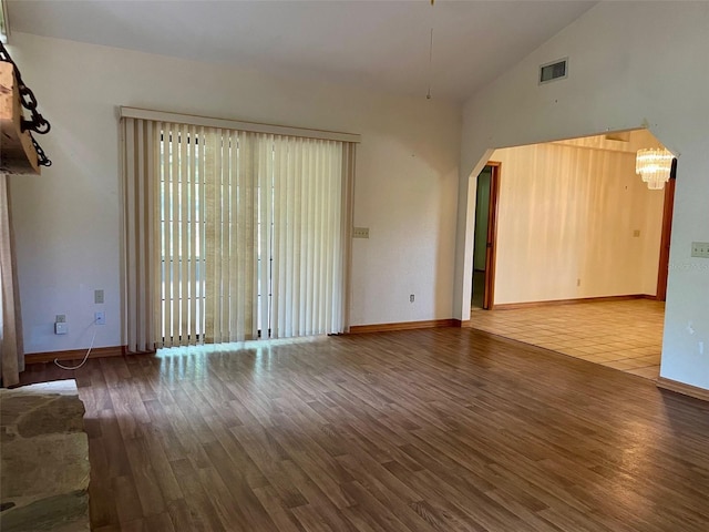 1112 NE 130th Ter, Silver Springs, FL 34488 - unfurnished living room with wood finished floors, a chandelier, and high vaulted ceiling