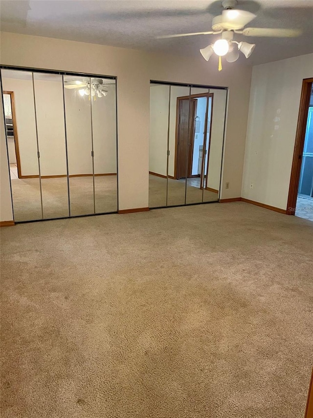 1112 NE 130th Ter, Silver Springs, FL 34488 - unfurnished bedroom featuring two closets, carpet flooring, and a ceiling fan