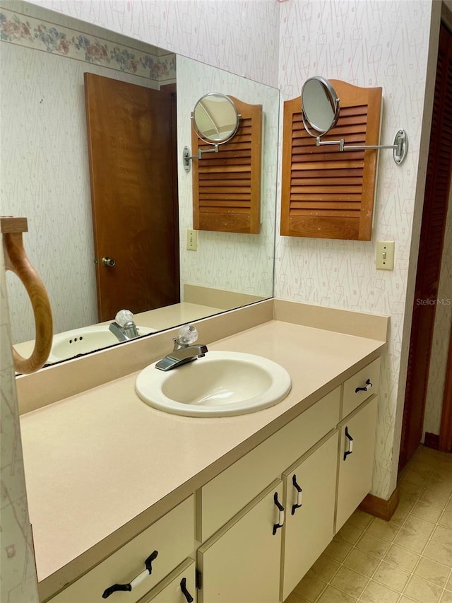 1112 NE 130th Ter, Silver Springs, FL 34488 - bathroom featuring wallpapered walls, vanity, and tile patterned flooring