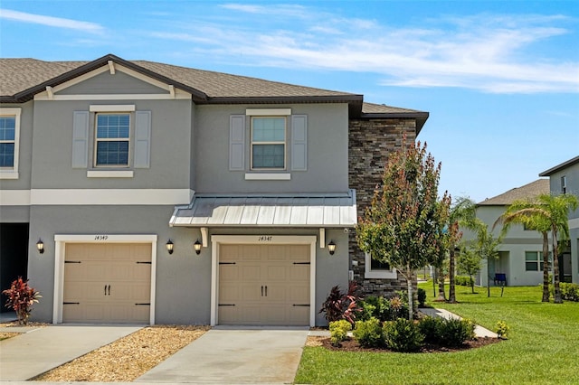14347 Easy Goer St, Ruskin, FL 33573 - multi unit property with an attached garage, concrete driveway, a front lawn, stucco siding, and a standing seam roof