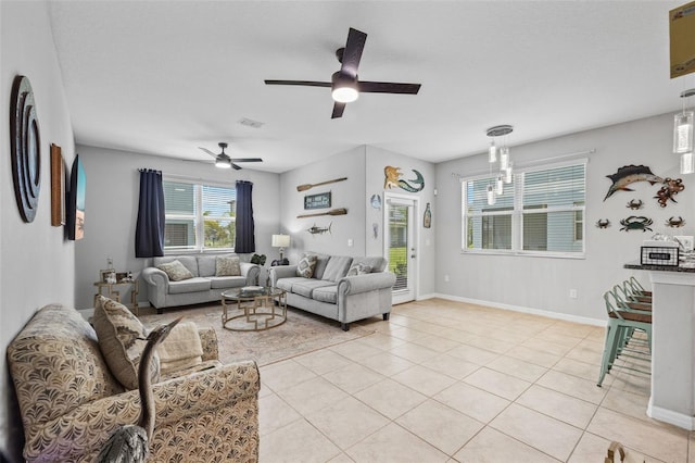14347 Easy Goer St, Ruskin, FL 33573 - living area with a ceiling fan and light tile patterned floors