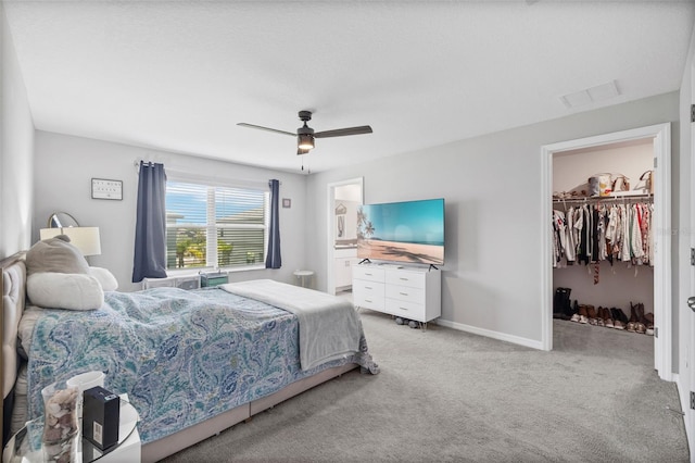 14347 Easy Goer St, Ruskin, FL 33573 - bedroom with light carpet, a spacious closet, a ceiling fan, and a closet