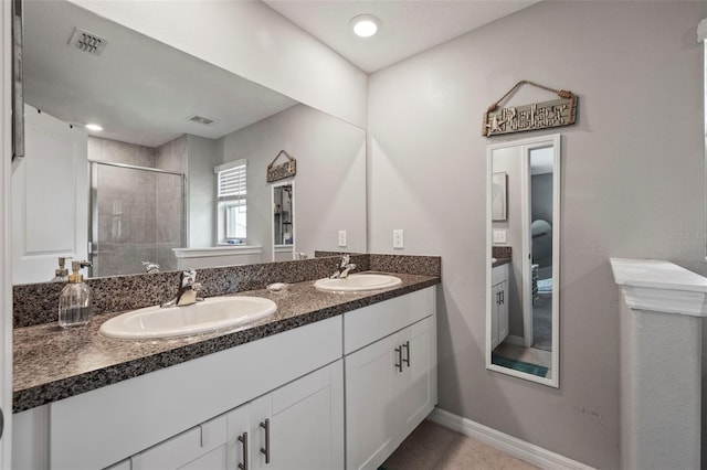 14347 Easy Goer St, Ruskin, FL 33573 - full bath featuring a stall shower, double vanity, and tile patterned flooring