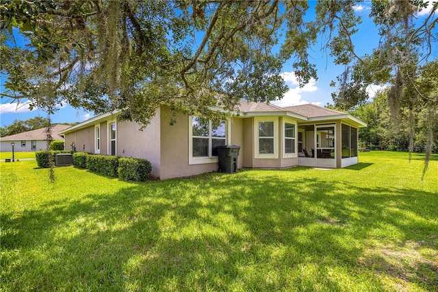 8 Diamond Club Rd, Ocala, FL 34472 - rear view of property with a yard, stucco siding, and a sunroom
