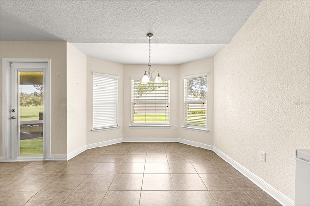 8 Diamond Club Rd, Ocala, FL 34472 - unfurnished dining area with a textured wall, a chandelier, a textured ceiling, and tile patterned flooring