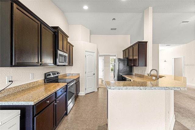 8 Diamond Club Rd, Ocala, FL 34472 - kitchen featuring stainless steel appliances, dark brown cabinets, a peninsula, light countertops, and recessed lighting