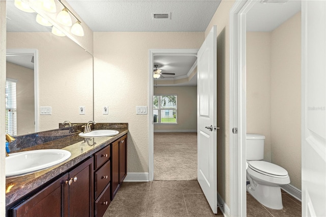 8 Diamond Club Rd, Ocala, FL 34472 - full bathroom with double vanity, a ceiling fan, tile patterned flooring, and a textured ceiling