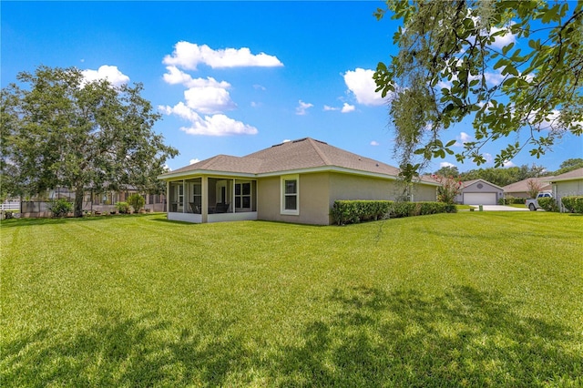 8 Diamond Club Rd, Ocala, FL 34472 - back of property with a sunroom, a yard, stucco siding, and a garage
