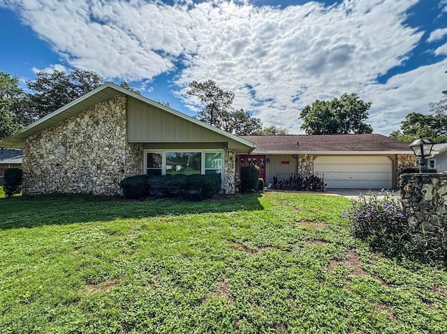 3545 SE 24th Ave, Ocala, FL 34471 - view of front of house with stone siding, an attached garage, a front yard, and driveway
