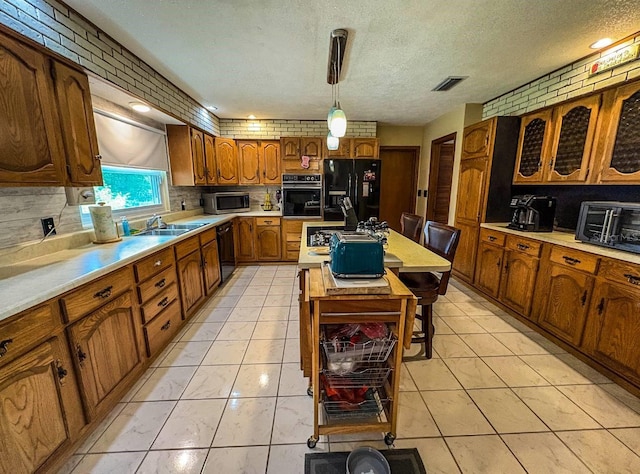 3545 SE 24th Ave, Ocala, FL 34471 - kitchen with black appliances, brown cabinetry, light countertops, tasteful backsplash, and a textured ceiling
