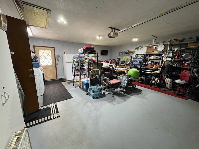 3545 SE 24th Ave, Ocala, FL 34471 - garage featuring a garage door opener, freestanding refrigerator, and washer / clothes dryer