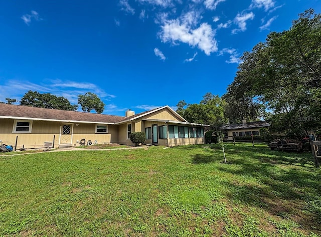 3545 SE 24th Ave, Ocala, FL 34471 - back of property with a lawn and a chimney