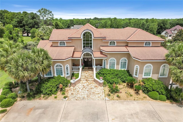 200 Asphodel Dr, Dothan, AL 36303 - mediterranean / spanish home featuring stucco siding, a tile roof, covered porch, and stairway