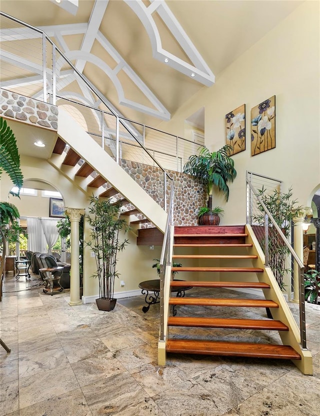 200 Asphodel Dr, Dothan, AL 36303 - staircase with ornate columns, high vaulted ceiling, arched walkways, and beamed ceiling