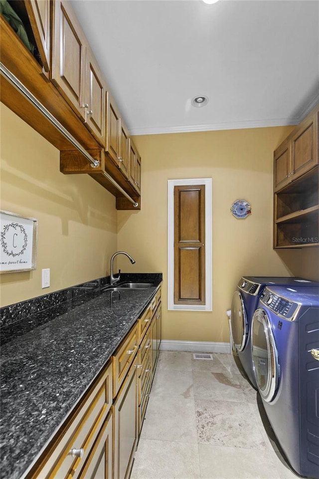 200 Asphodel Dr, Dothan, AL 36303 - laundry area with washing machine and clothes dryer, ornamental molding, and cabinet space