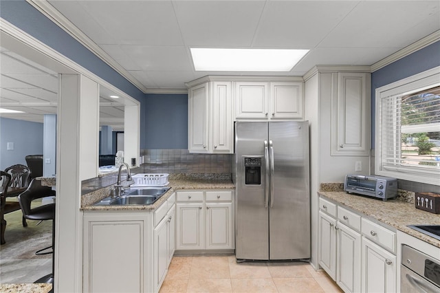 200 Asphodel Dr, Dothan, AL 36303 - kitchen with appliances with stainless steel finishes, a drop ceiling, light tile patterned floors, backsplash, and crown molding