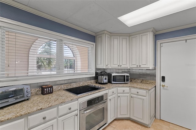 200 Asphodel Dr, Dothan, AL 36303 - kitchen with stainless steel appliances, light tile patterned floors, white cabinets, light stone countertops, and crown molding