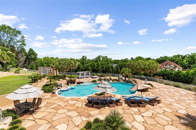 200 Asphodel Dr, Dothan, AL 36303 - view of pool with a patio area, view of wooded area, and an outbuilding